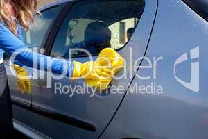 Close-up of a woman cleaning her car