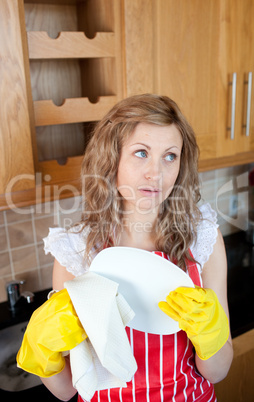 Attractive young woman drying dishes