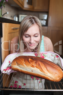Delighted blond woman baking bread