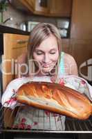 Delighted blond woman baking bread