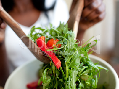 Afro-american woman preparing a salad