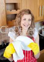 Laughing blond woman drying dishes