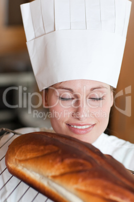 Bright female chef baking bread