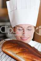 Bright female chef baking bread