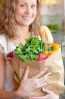 Smiling woman holding a grocery bag