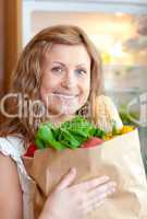 Radiant woman holding a grocery bag