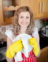 Smiling woman drying dish