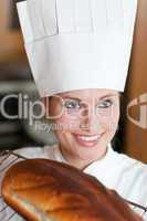 Confident female chef baking bread