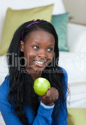 Cheerful woman eating an apple