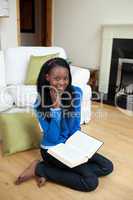 Chrming woman reading a book sitting on the floor