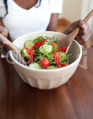 Young woman preparing a salad