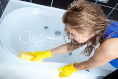 Young woman cleaning a bath