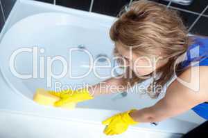 Young woman cleaning a bath