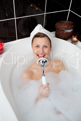 Happy woman singing in a bubble bath