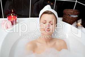 Beautiful woman relaxing in a bubble bath