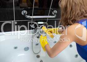 Woman cleaning with a sponge and detergent spray