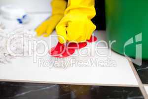 Woman cleaning a bathroom's floor