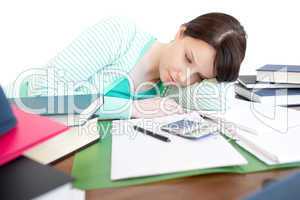 Exhausted bright woman studying on a table