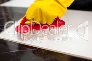 Close-up of a person cleaning a bathroom's floor