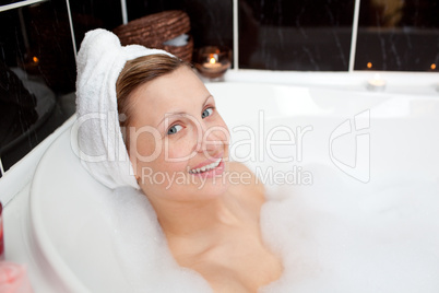 Caucasian woman taking in a bubble bath