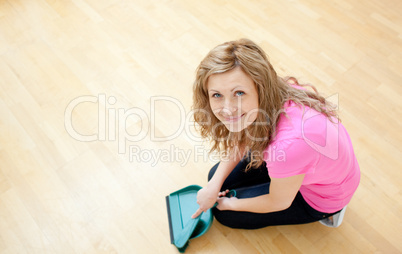 Smiling young woman cleaning the floor