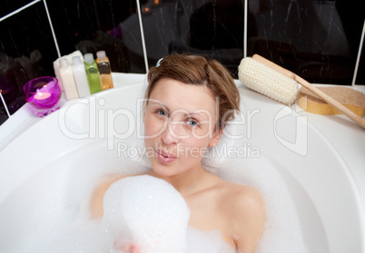 Young woman playing in a bubble bath