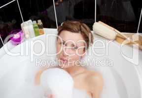 Young woman playing in a bubble bath