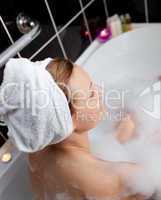 Caucasian woman taking in a bubble bath