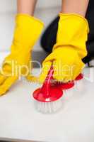 Close-up of a woman cleaning a bathroom's floor