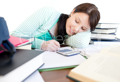 Attractive student doing her homework on a desk