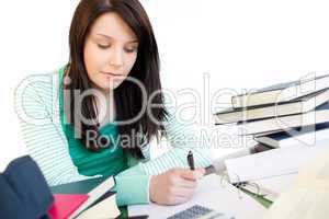 Positive student doing her homework on a desk