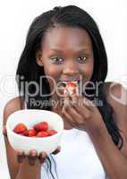 Bright Afro-american a woman eating strawberries