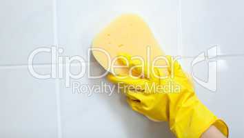 Close-up of a woman cleaning a bathroom