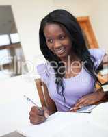 Beautiful young woman doing her homework