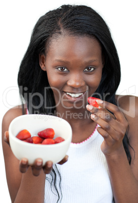 Radiant Afro-american a woman eating strawberries