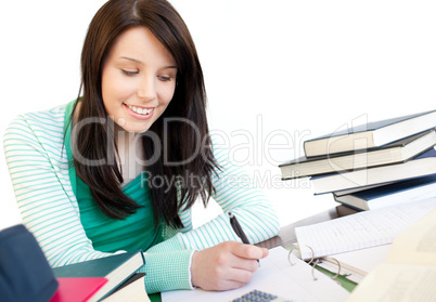 Smiling teen girl studying on a desk