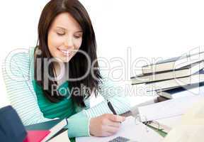 Smiling teen girl studying on a desk