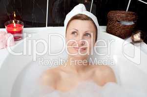 Radiant woman relaxing in a bubble bath
