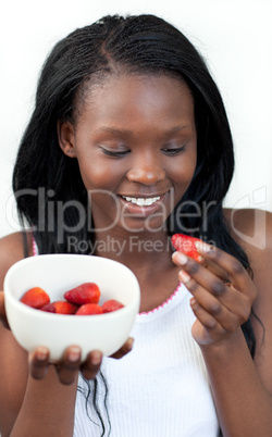 Cheerful Afro-american a woman eating strawberries