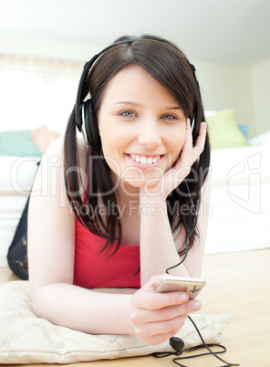 Cheerful woman listening music with headphones on