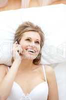 Laughing woman in underwear talking on phone