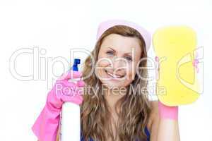 Smiling woman holding a sponge and a detergent spray