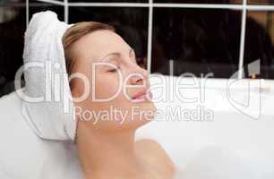 Bright woman relaxing in a bubble bath
