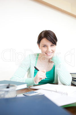 Happy young woman studying