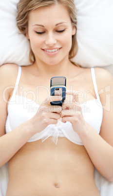Positive woman in underwear sending a text