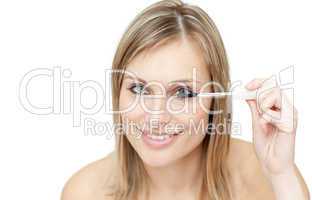 Radiant woman putting mascara