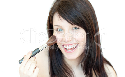 Happy woman using a powder brush