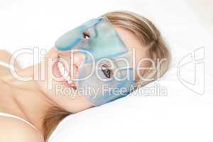 Smiling woman with an eye gel mask