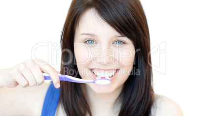 Smiling woman brushing her teeth
