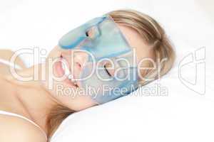 Relaxed woman with an eye gel mask
